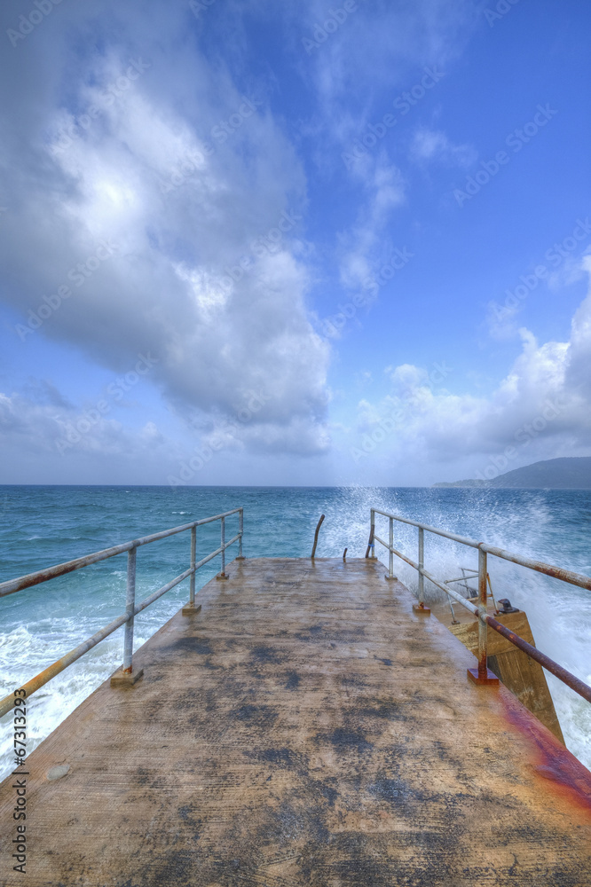 Fototapeta premium Ocean view and clouds on the bridge with heavy waves