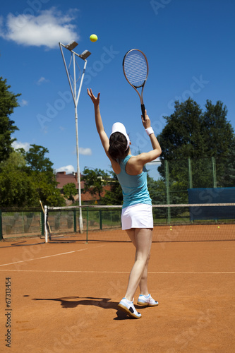 Girl playing tennis on the court