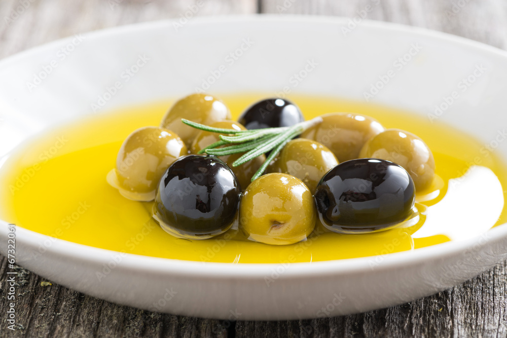 fresh olive oil and olives in a plate, close-up fresh olive oil and olives in a plate, close-up