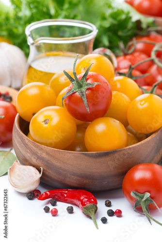 yellow and red cherry tomatoes, olive oil and spices, close-up