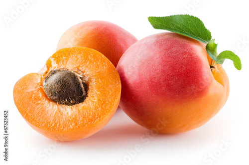 Apricots with leaves on a white background.