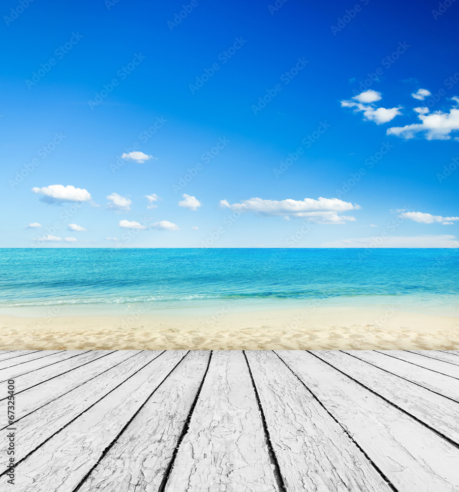 Empty wooden pier beside tropical beach