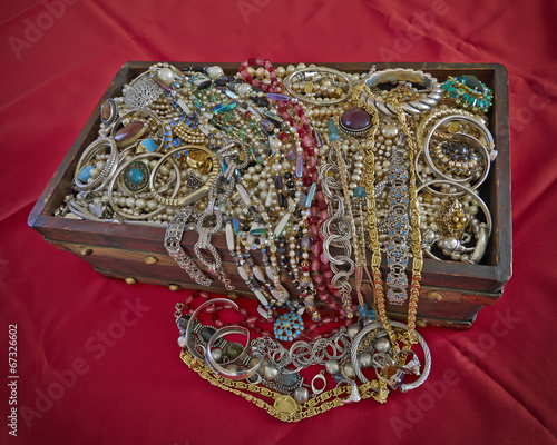 vintage box full of shiny jewelry