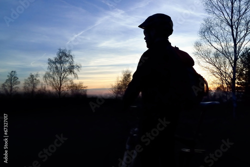 Mountain biker on a mountain track at sunset