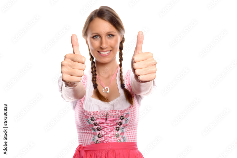 Eine junge Frau im Dirndl gibt ein Daumen hoch Zeichen Eine junge Frau im Dirndl gibt ein Daumen hoch Zeichen