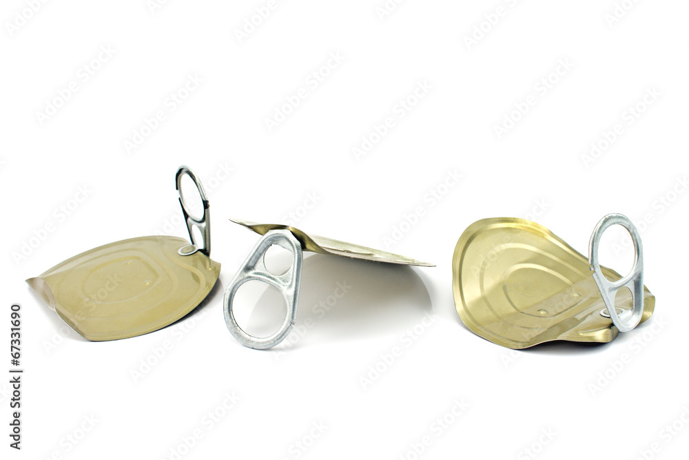Three tin can lids with opener on white Three tin can lids with opener on white