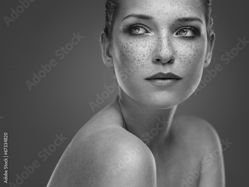 Black and White Portrait of a beautiful brunette with freckles photo