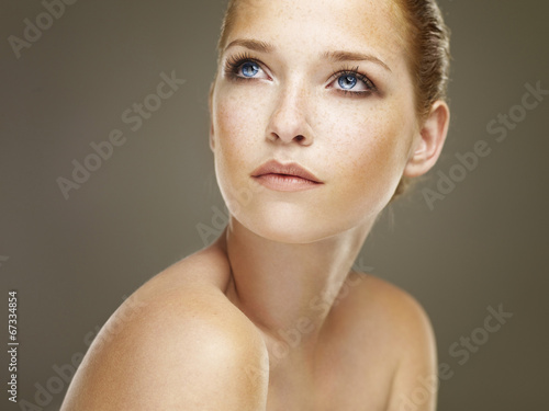 Portrait of a beautiful brunette with freckles