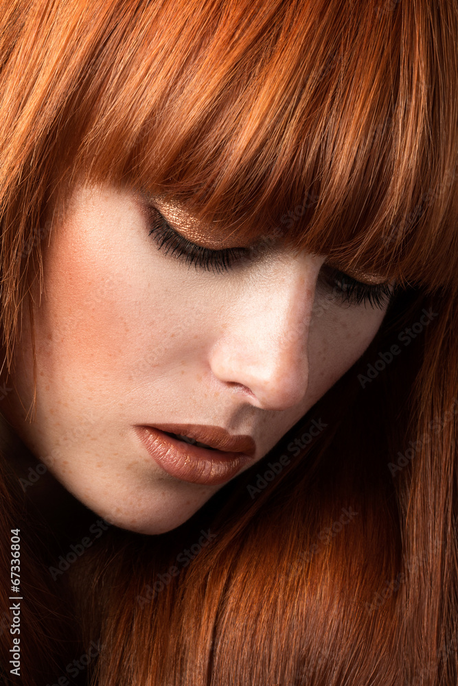 Red haired girl looking down portrait Red haired girl looking down portrait