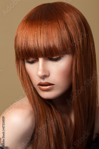 Red haired girl looking down portrait