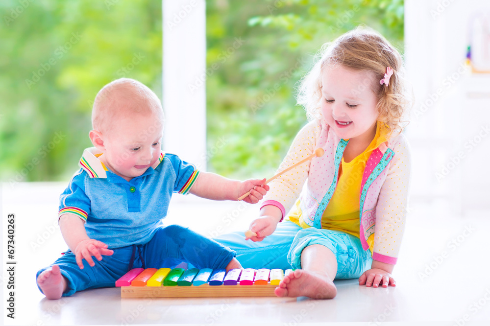 Happy kids playing music with xylophone Happy kids playing music with xylophone
