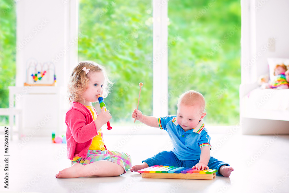 Sweet kids playing music with xylophone Sweet kids playing music with xylophone