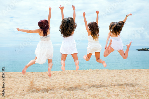 Photography Teen girls jumping on beach