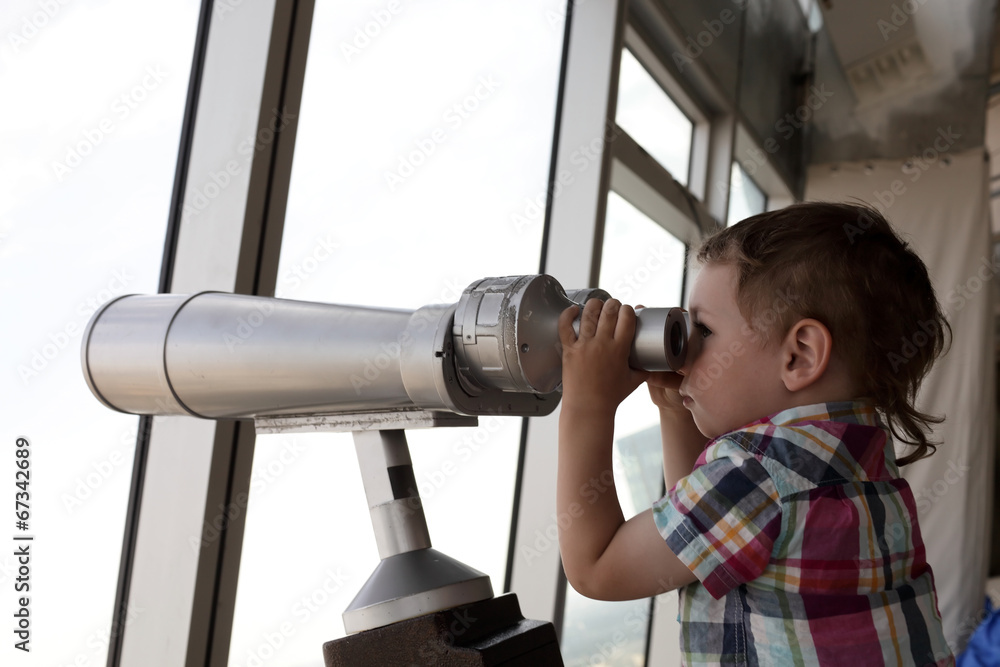 Child looking through pay binoculars