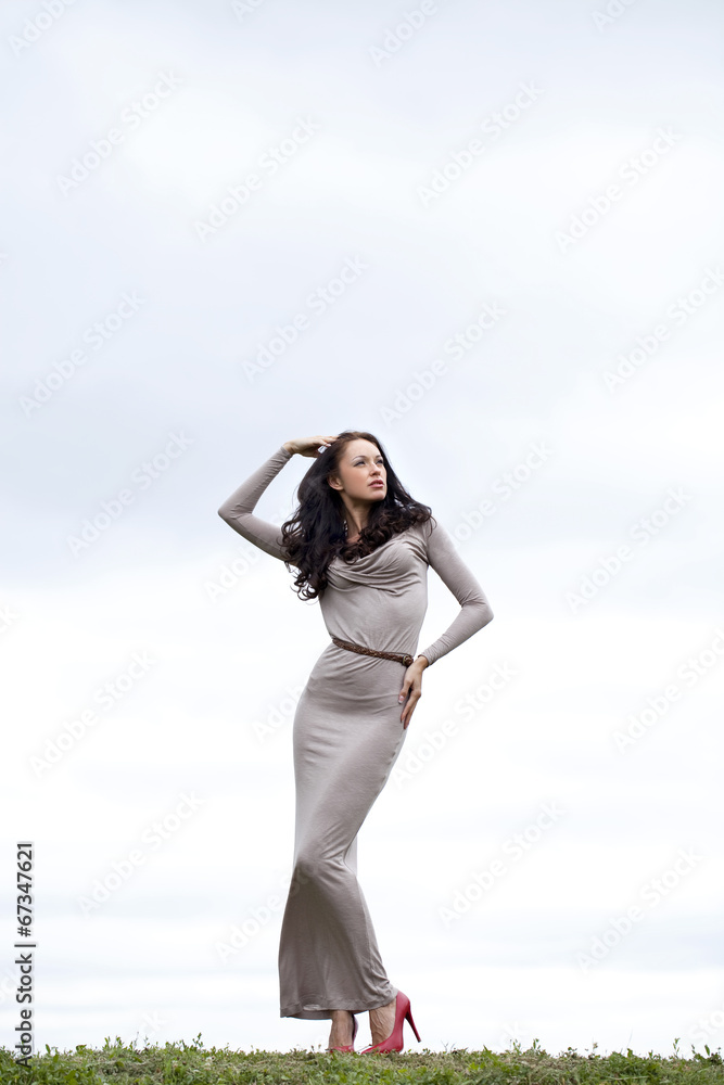 Young woman in sexy long gray dress Young woman in sexy long gray dress