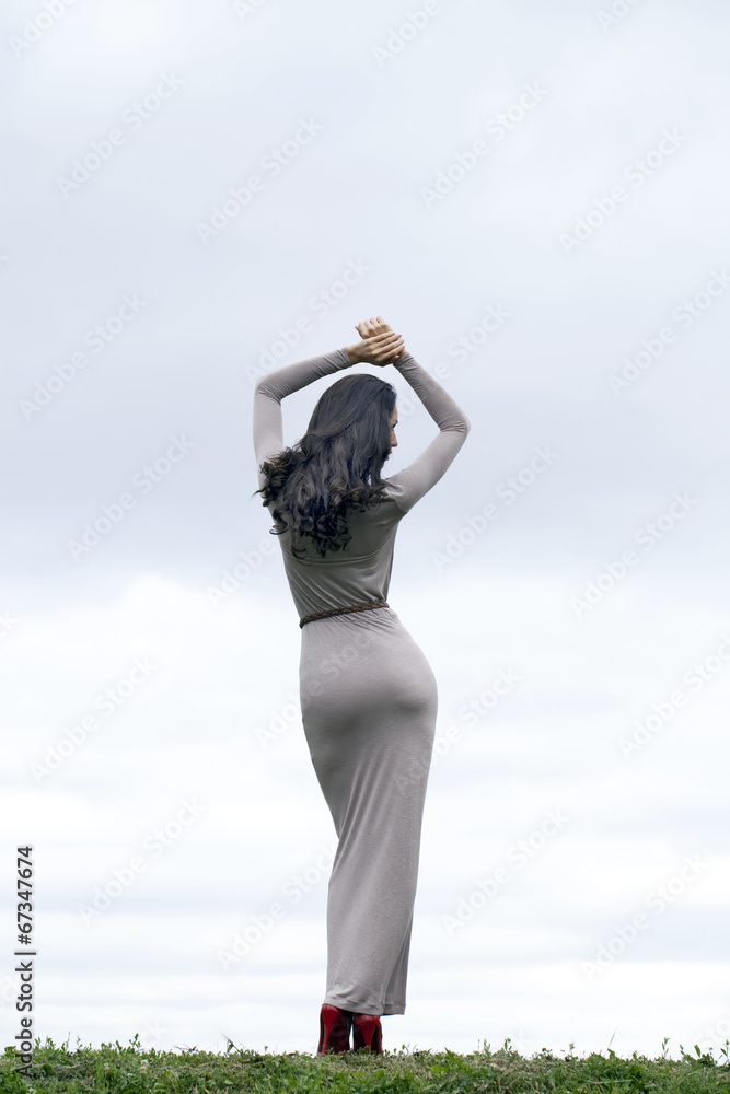 Young woman in sexy long gray dress Young woman in sexy long gray dress