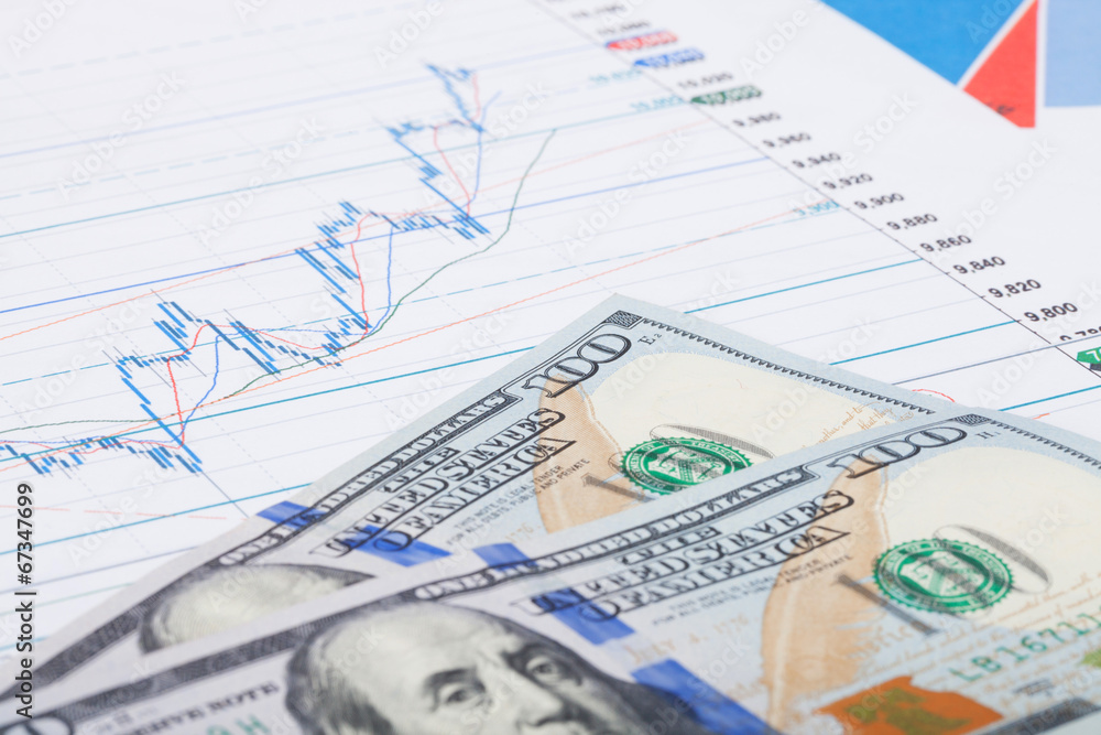 Stock market graph with 100 dollars banknote - studio shot Stock market graph with 100 dollars banknote - studio shot