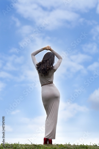 Young woman in sexy long gray dress