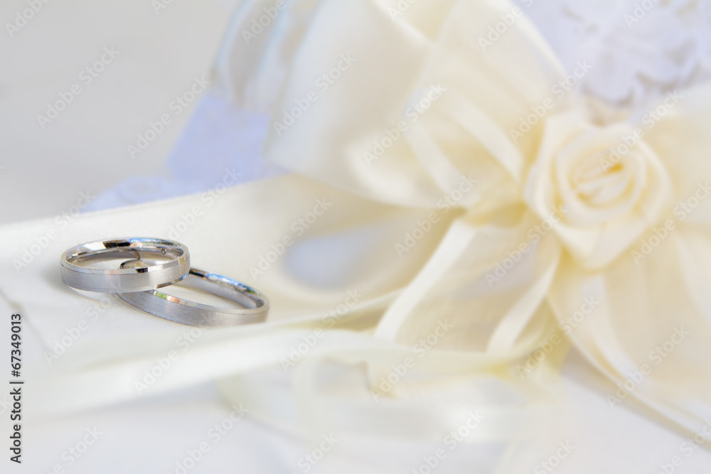 wedding rings and decoration over white wedding rings and decoration over white
