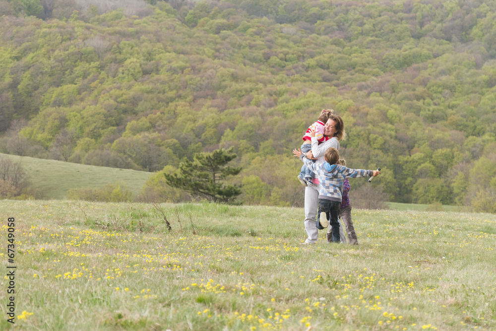 happy family with three kids enjoying free time on natural backg happy family with three kids enjoying free time on natural backg