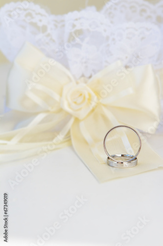 wedding rings and decoration over white