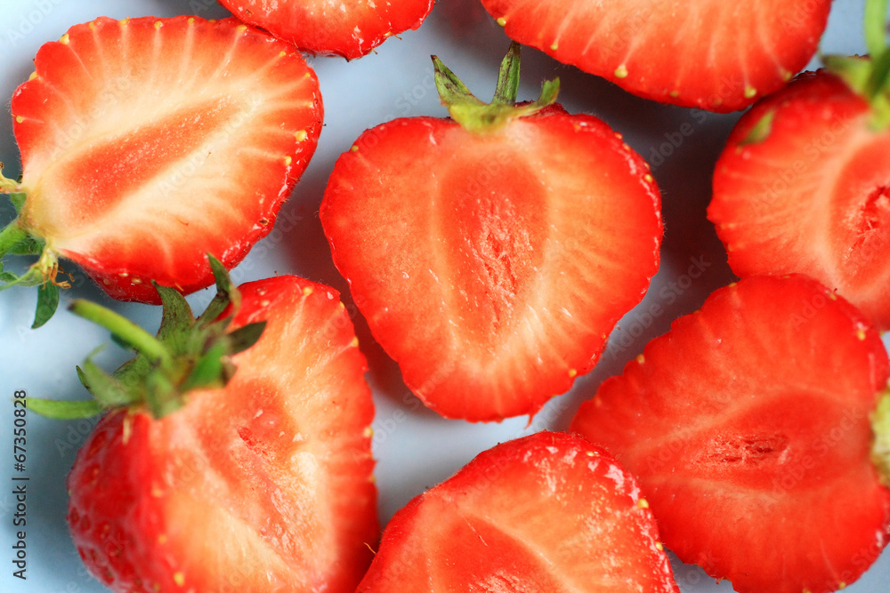 Fresh strawberries in a blue bowl, close up Fresh strawberries in a blue bowl, close up
