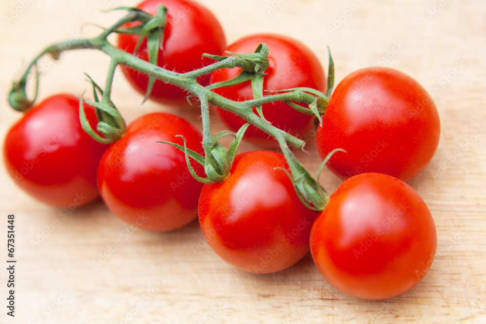 Cherry tomatoes on wooden table close up Cherry tomatoes on wooden table close up