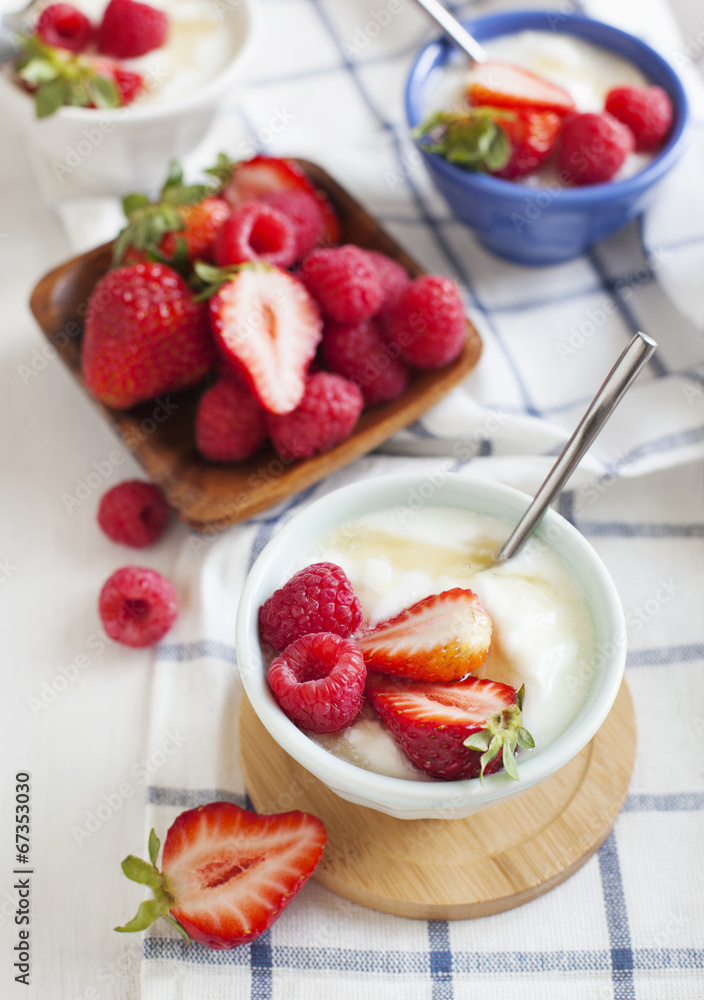 Yogurt with berries and honey in small bowl Yogurt with berries and honey in small bowl
