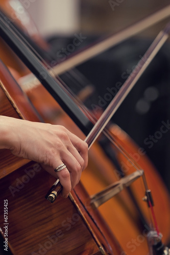 Hand girl playing cello closeup