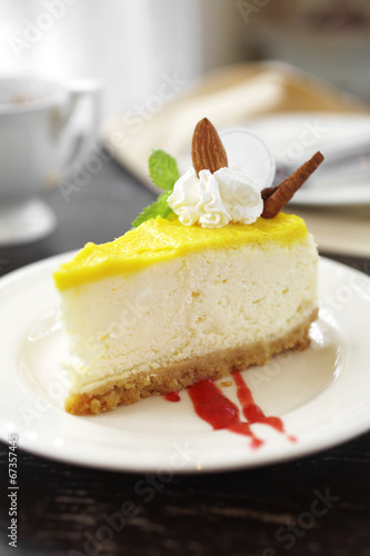 close up lemon cheese cake in white dish