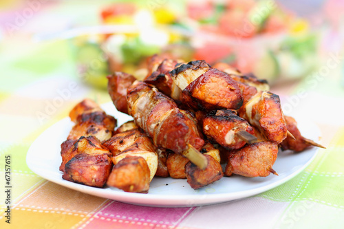 Assorted delicious grilled meat on white plate