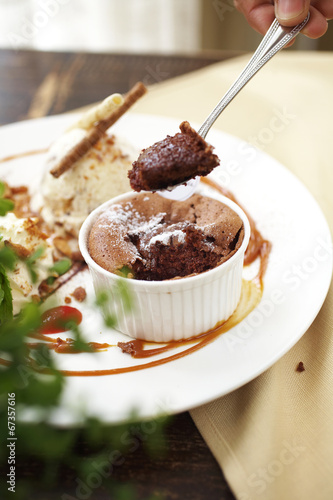 close up chocolate cup cake with caramel sauce and spoon