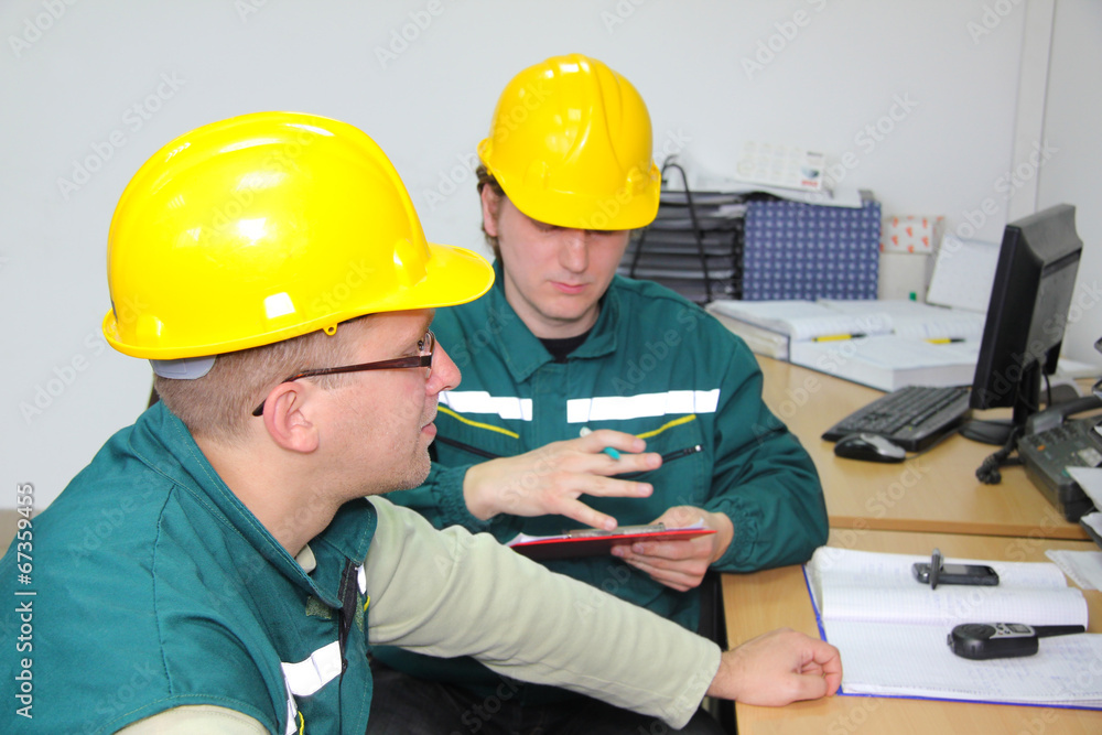Industrial workers in control room, teamwork Industrial workers in control room, teamwork