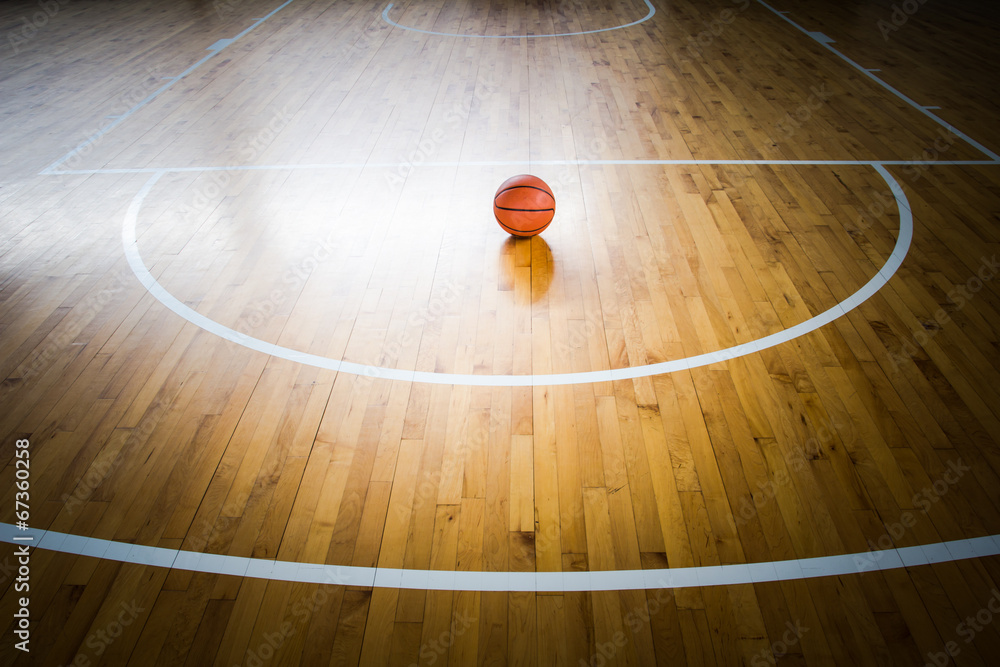 Basketball ball over floor in the gym