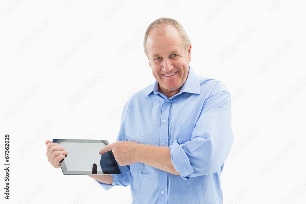 Happy mature man pointing to his tablet pc Happy mature man pointing to his tablet pc