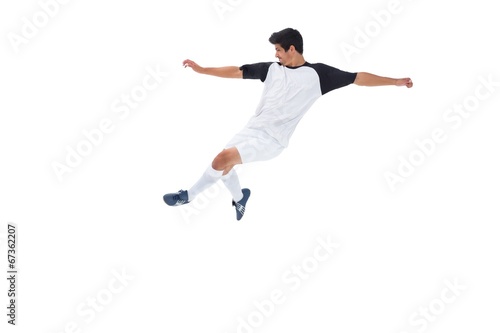Football player in white kicking © WavebreakmediaMicro