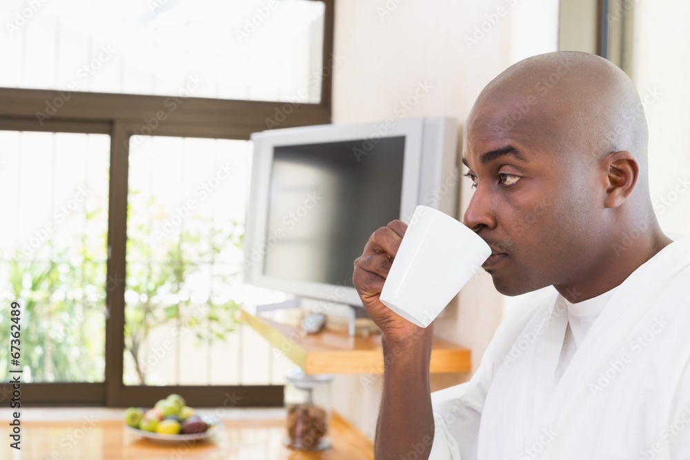 Happy man in bathrobe drinking coffee Happy man in bathrobe drinking coffee