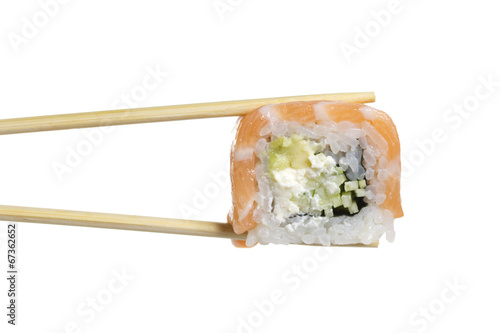Sushi roll in chopsticks isolated on white background
