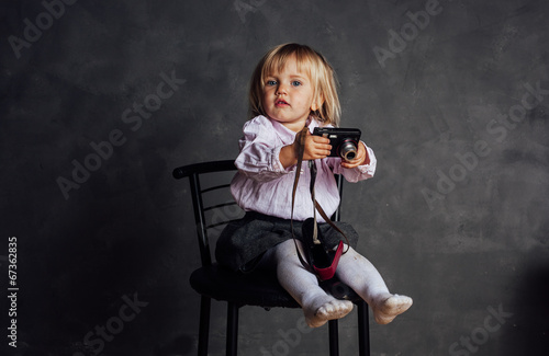 Little girl in dress and hat photographs