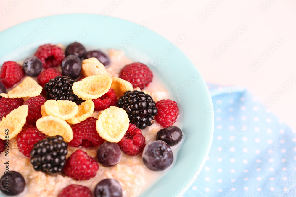 Oatmeal in bowl with berries isolated on white Oatmeal in bowl with berries isolated on white