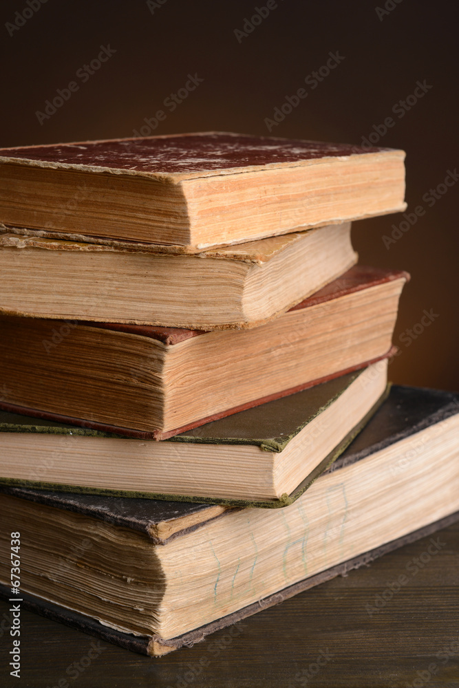 Old books on table on brown background Old books on table on brown background