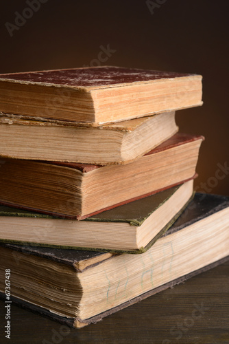 Old books on table on brown background