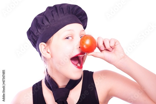 Teen girl in chef hat with tomatoes