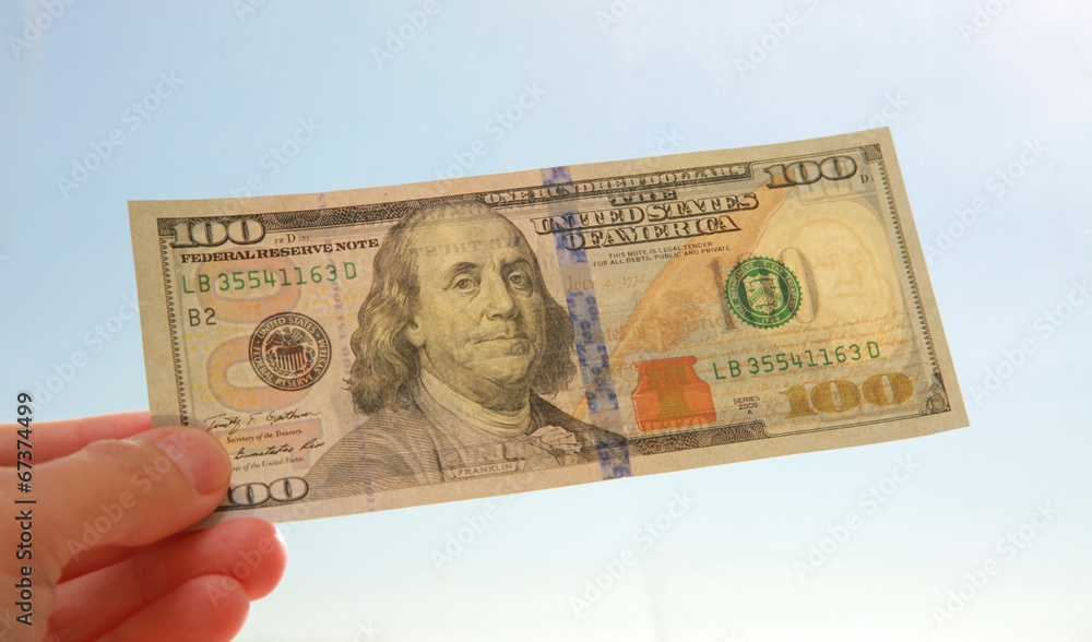 One hundred dollar banknote in sunlight One hundred dollar banknote in sunlight