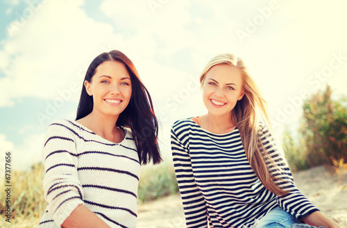 smiling girlfriends having fun on the beach photo