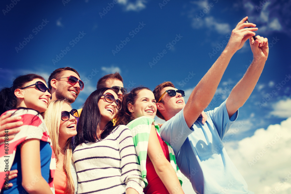 group of friends taking picture with smartphone group of friends taking picture with smartphone