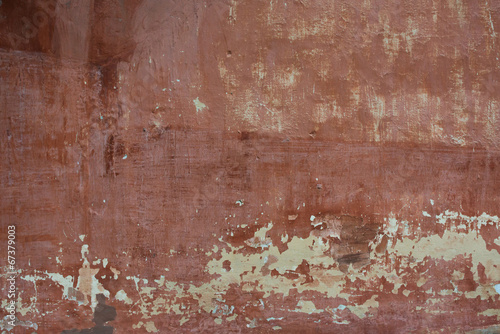Rough textured background red old cement wall with stains, dry