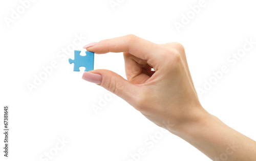 Woman hand hold a puzzle. Creative concept.