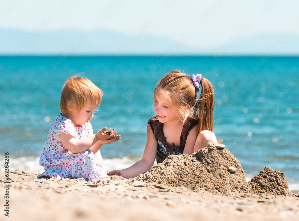 little girl builds a tower of sand little girl builds a tower of sand