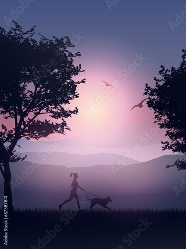 Female jogging in the coountryside with her dog photo